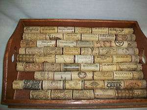   Wine Bottle Cork & Rubber Stoppers glued on a wooden tray  