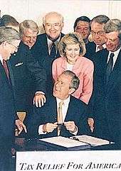 president bush signing a $ 1 35 trillion tax cut into law june 7 2001